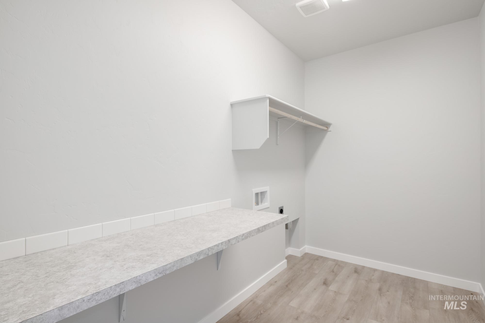 13708 Judson Street Caldwell, ID 83607 - Photo 20 of 32 Washroom with light wood-style flooring and electric dryer hookup