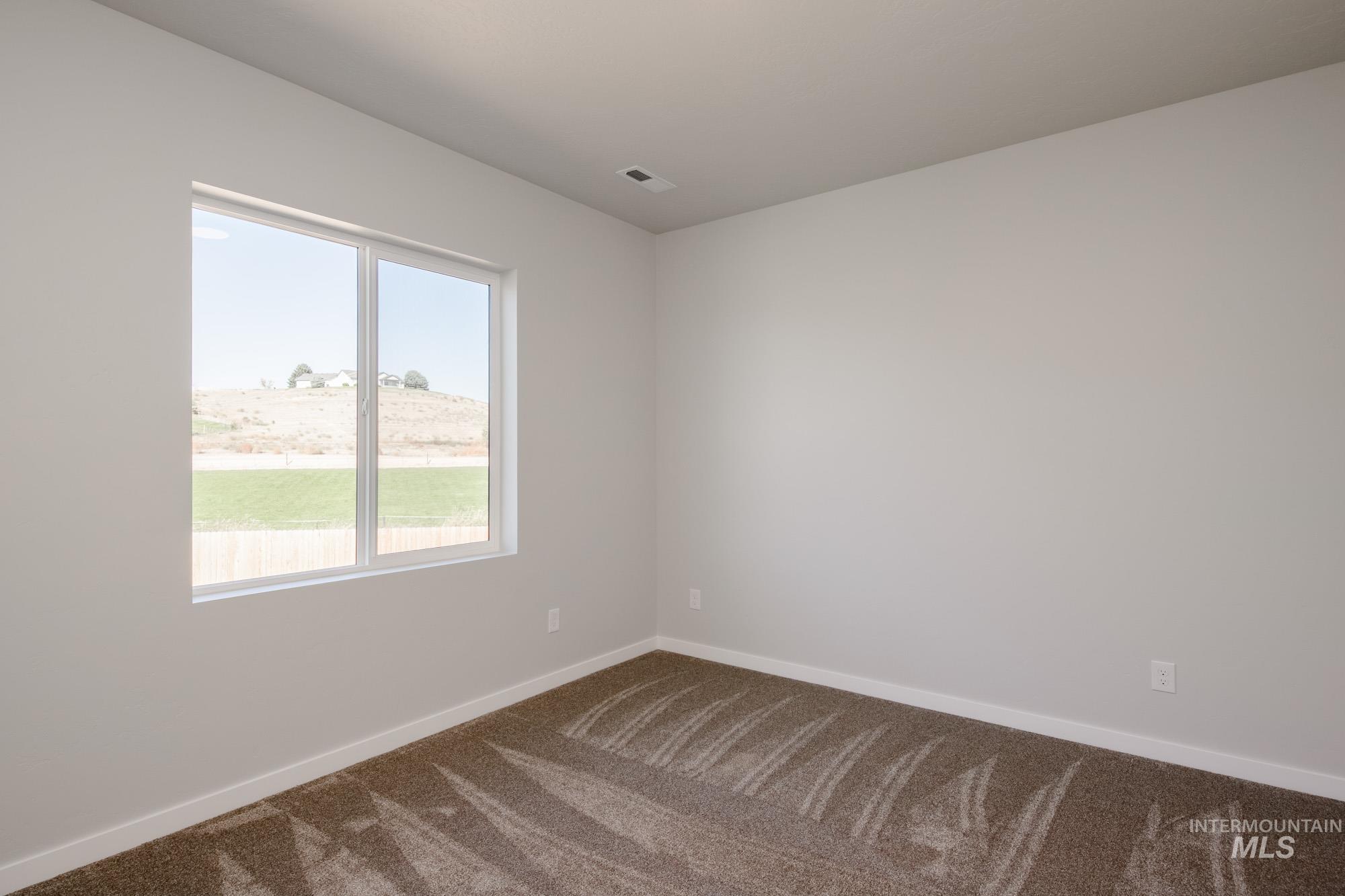 13708 Judson Street Caldwell, ID 83607 - Photo 21 of 32 Carpeted spare room featuring baseboards
