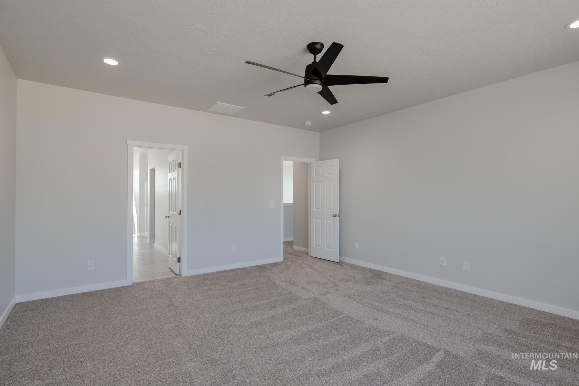 13708 Judson Street Caldwell, ID 83607 - Photo 27 of 32 Unfurnished bedroom with a ceiling fan, light colored carpet, and recessed lighting
