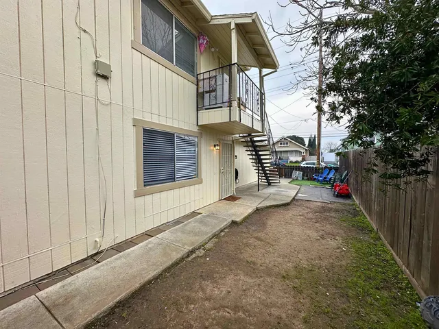 an empty room with a wooden floor and windows