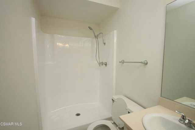 a bathroom with a shower and toilet