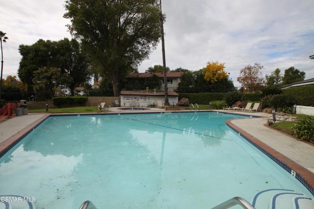 a view of a swimming pool with a yard