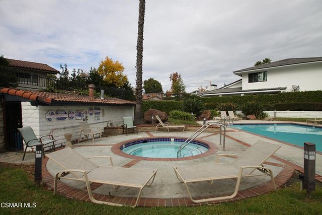 a swimming pool with outdoor seating and yard