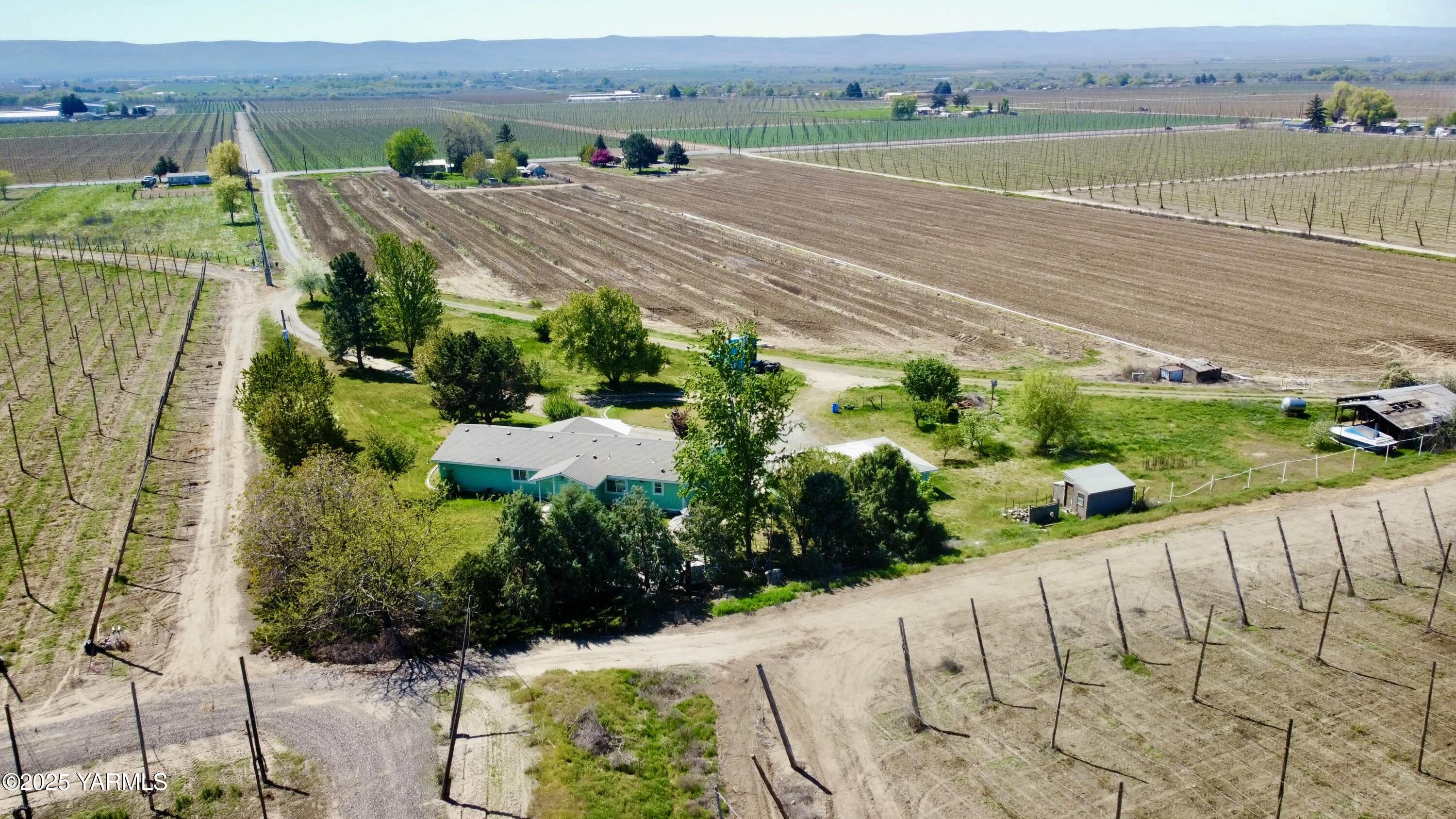 2751 Grandview Pavement Road Mabton, WA 98935 - Photo 3 of 23 an aerial view of a house with a garden and mountain view