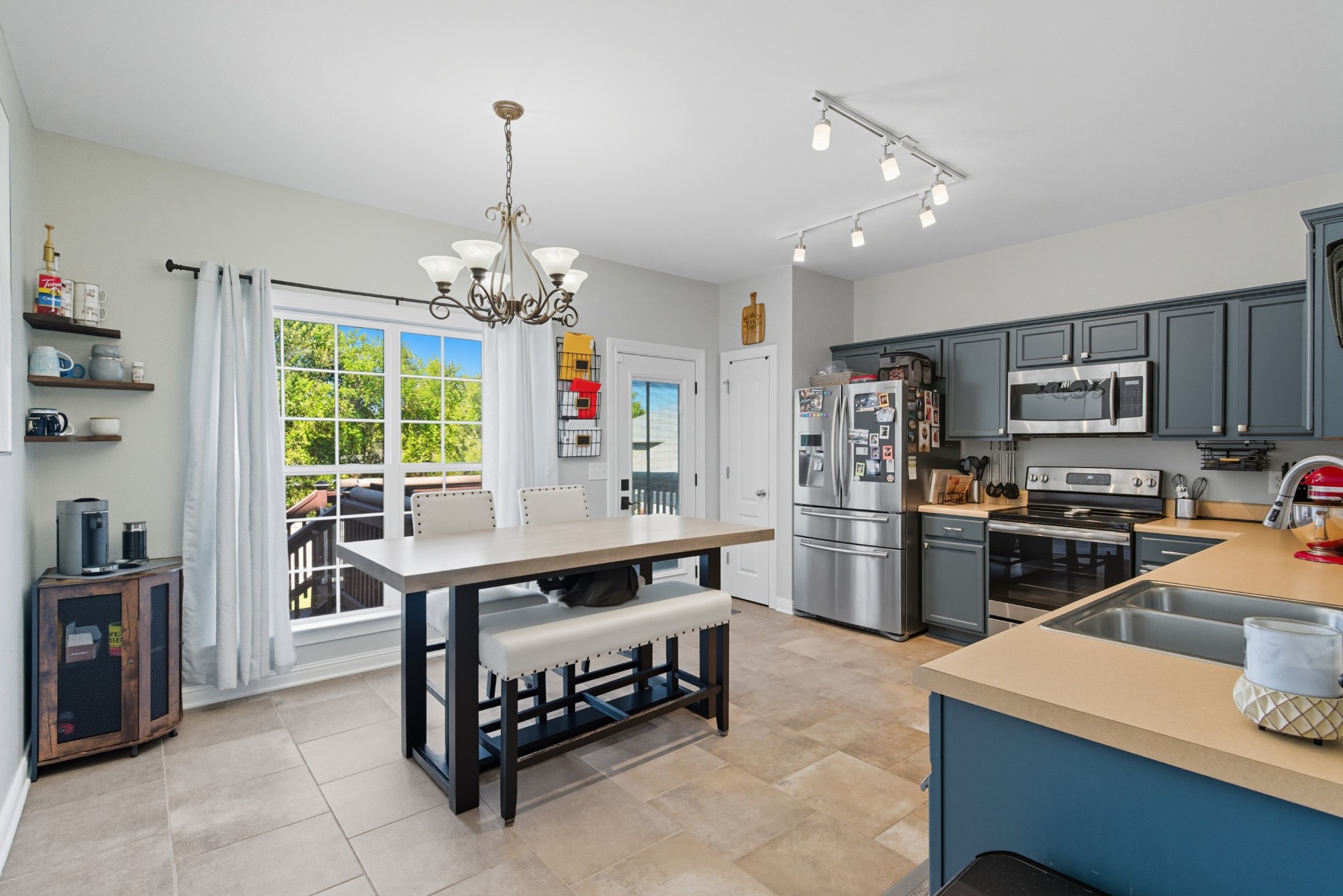 1511 Saddle View Mount Juliet, TN 37122 - Photo 12 of 52 a living room with stainless steel appliances furniture a chandelier and a kitchen view