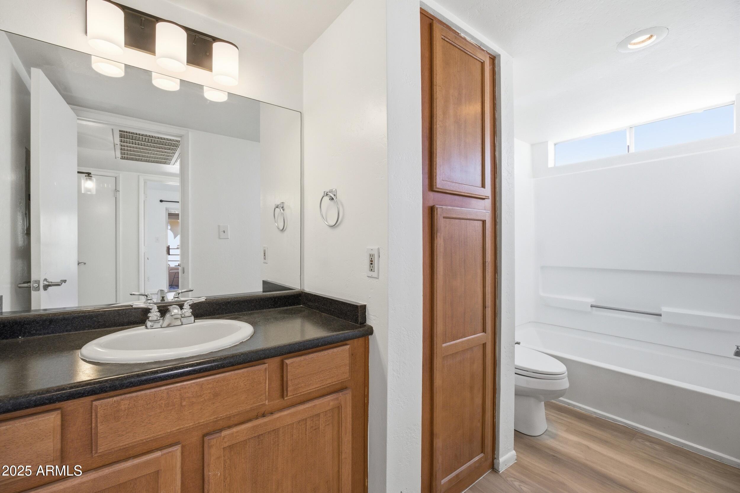 3845 East Greenway Road, Unit 230 Phoenix, AZ 85032 - Photo 10 of 37 a bathroom with a granite countertop sink toilet and shower