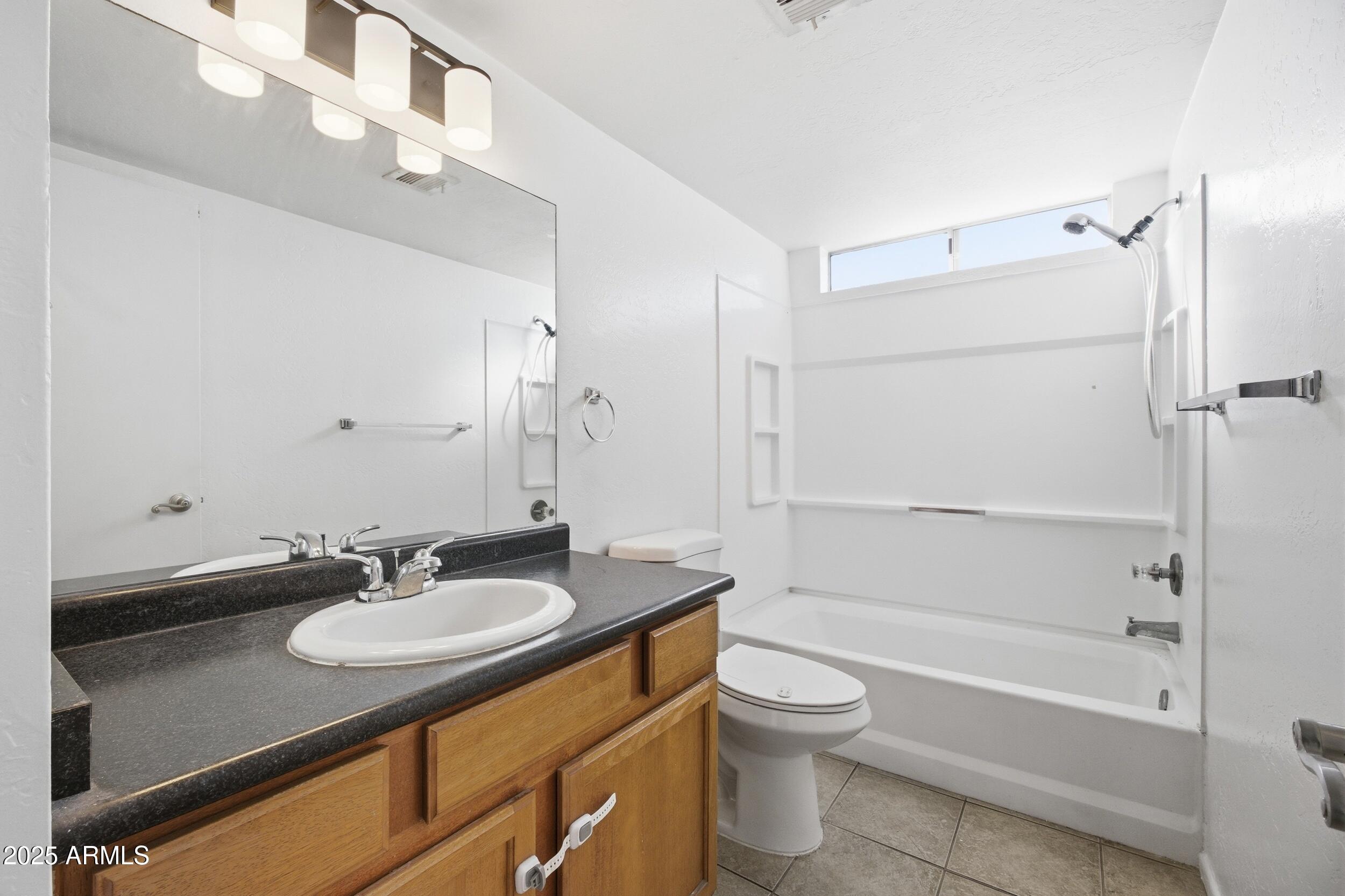 3845 East Greenway Road, Unit 230 Phoenix, AZ 85032 - Photo 16 of 37 a bathroom with a granite countertop sink toilet and shower