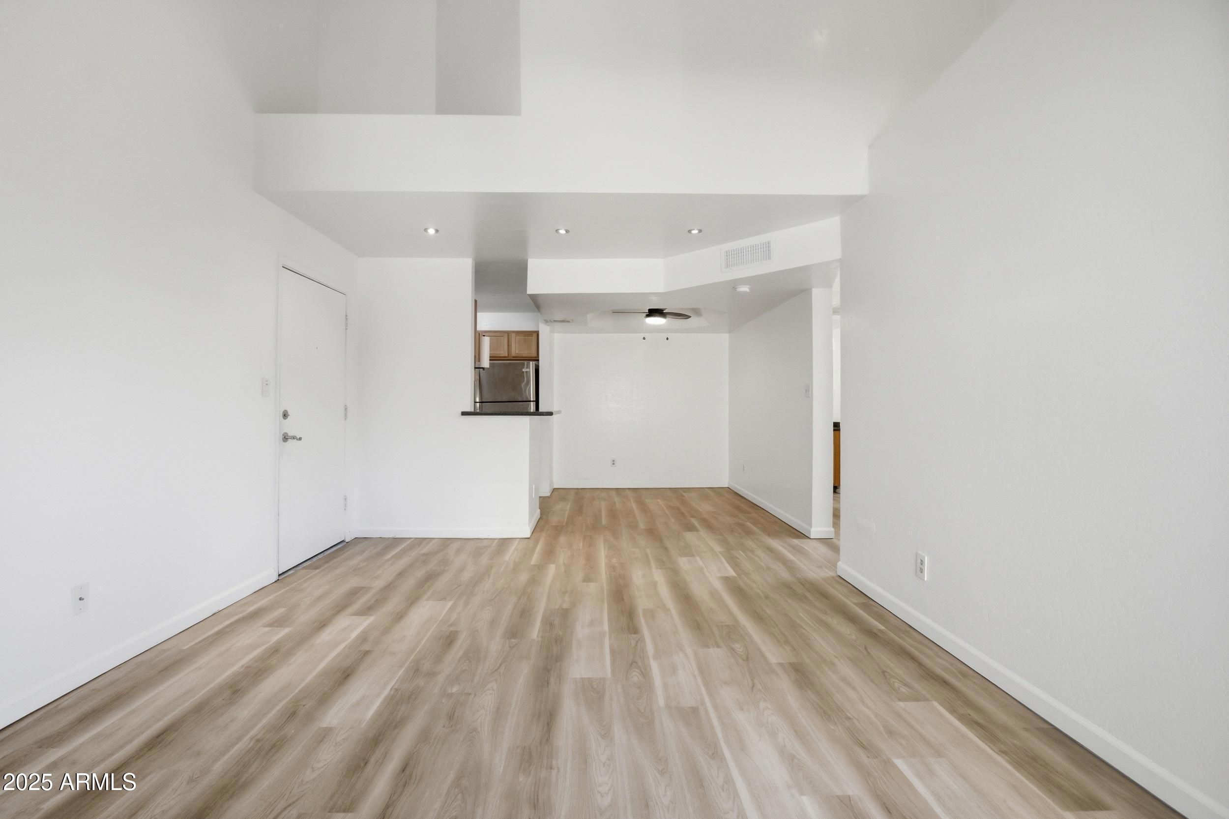 3845 East Greenway Road, Unit 230 Phoenix, AZ 85032 - Photo 3 of 37 a view of empty room with wooden floor
