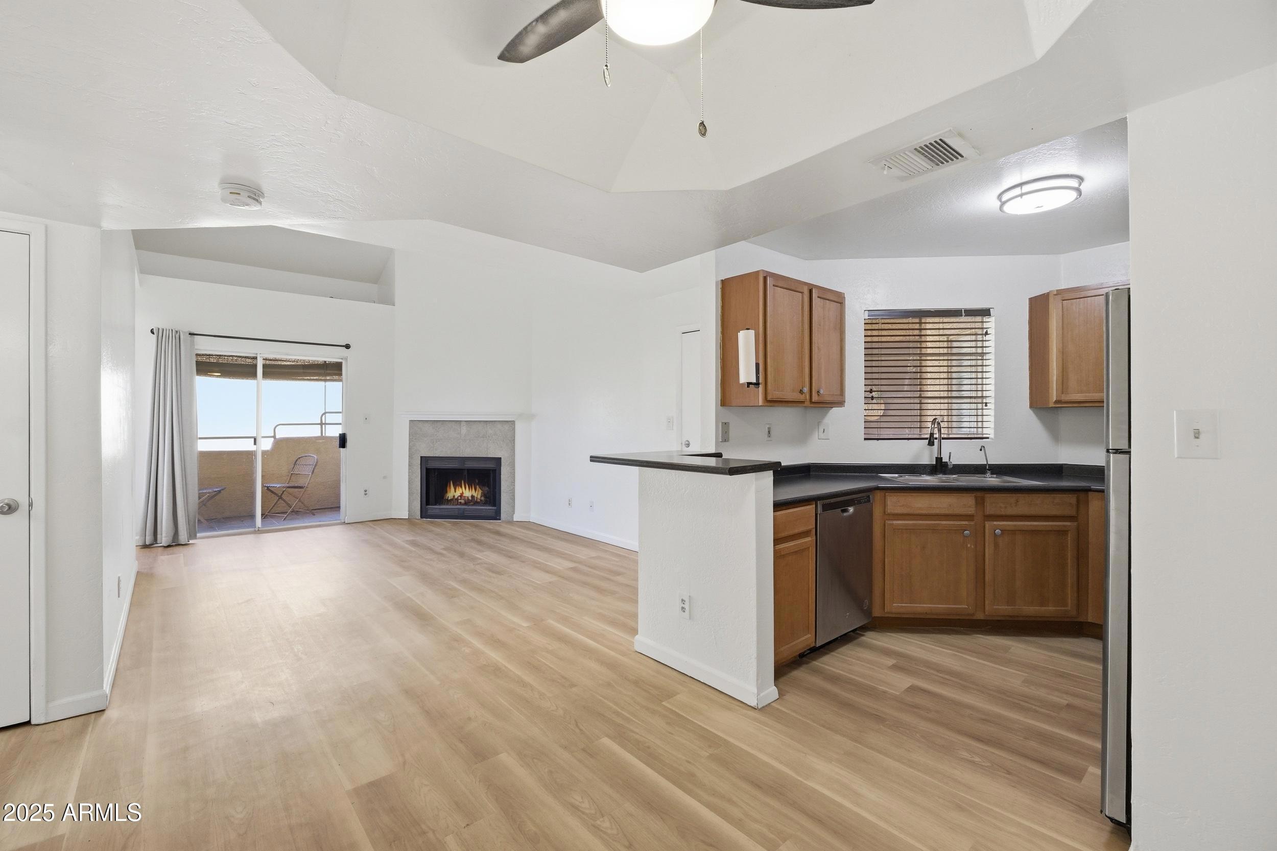 3845 East Greenway Road, Unit 230 Phoenix, AZ 85032 - Photo 4 of 37 a large kitchen with cabinets and wooden floor