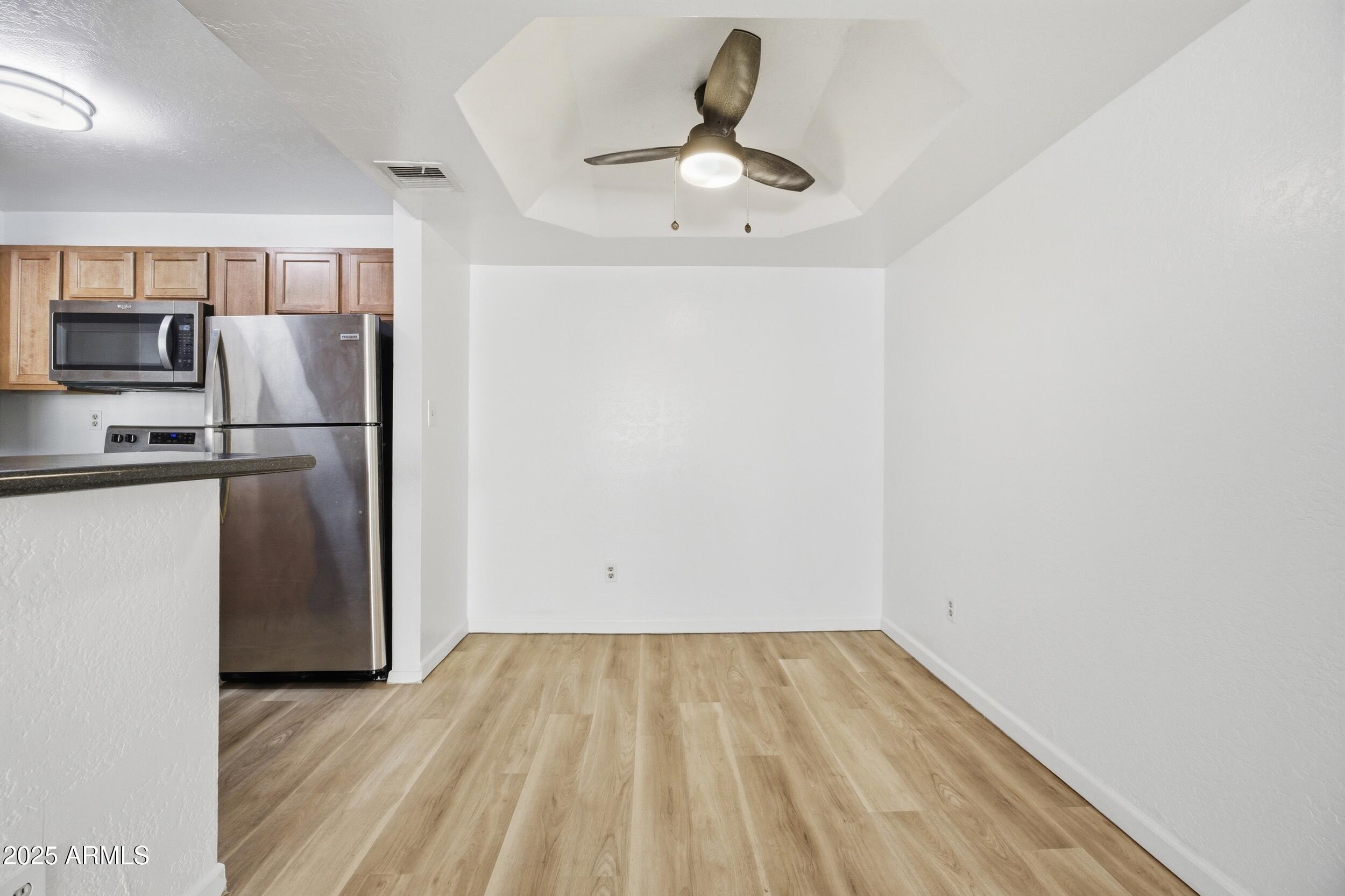 3845 East Greenway Road, Unit 230 Phoenix, AZ 85032 - Photo 7 of 37 a view of a kitchen with a sink and refrigerator