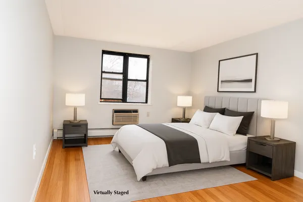 a bedroom with a bed and a lamp