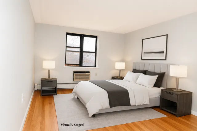 a bedroom with a bed and a lamp