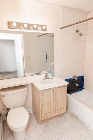 a bathroom with a sink a toilet and a mirror