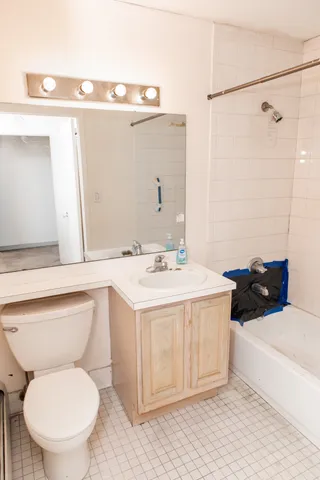 a bathroom with a sink a toilet and a mirror