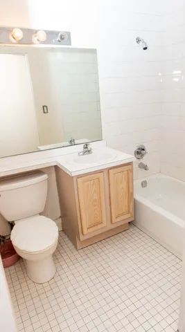 a bathroom with a toilet a sink and bathtub