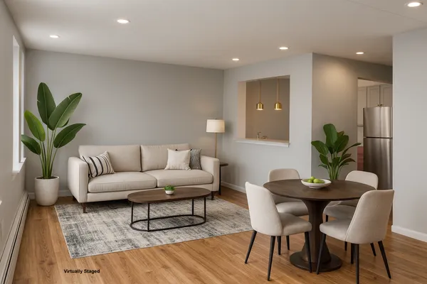 a living room with furniture a potted plant and a chandelier