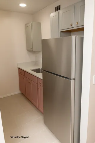 a kitchen with stainless steel appliances granite countertop a refrigerator and a cabinets
