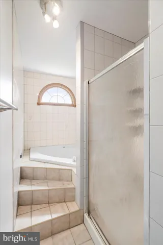 a bathroom with a glass shower door