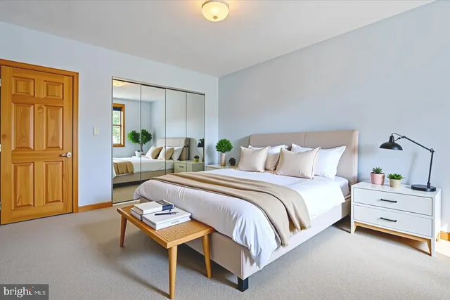 a bedroom with a bed and a lamp