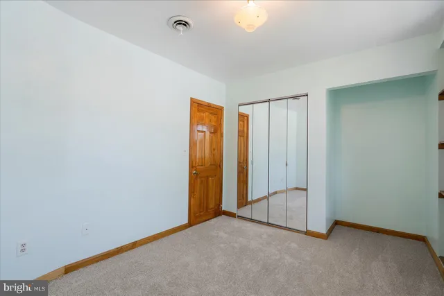 an empty room with a mirror