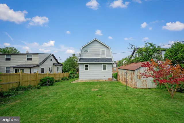 a view of a house with a yard and garden