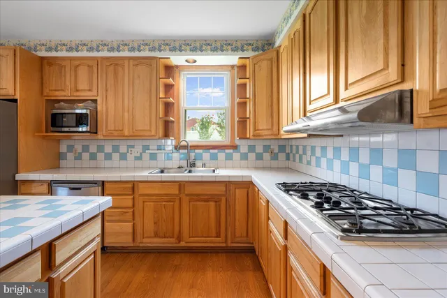 a kitchen with a stove a sink and a microwave