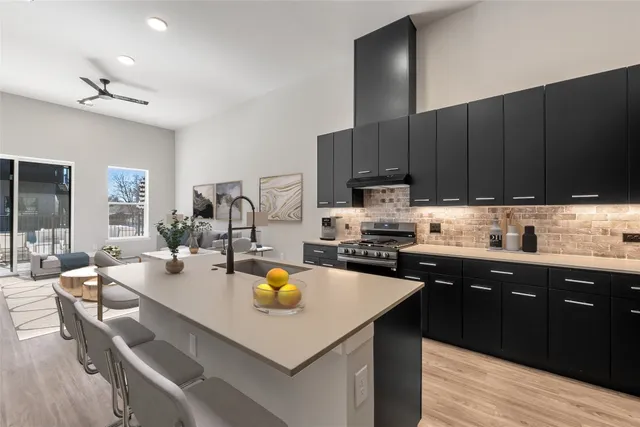 a kitchen with a sink a stove and cabinets