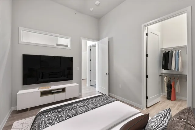 a bedroom with a bed and a flat screen tv