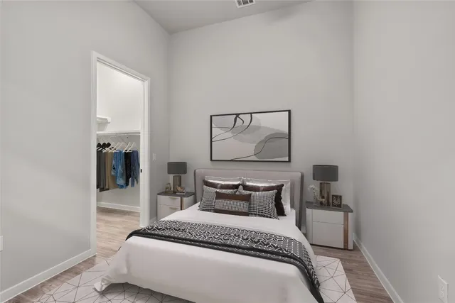 a view of walk in closet with clothes