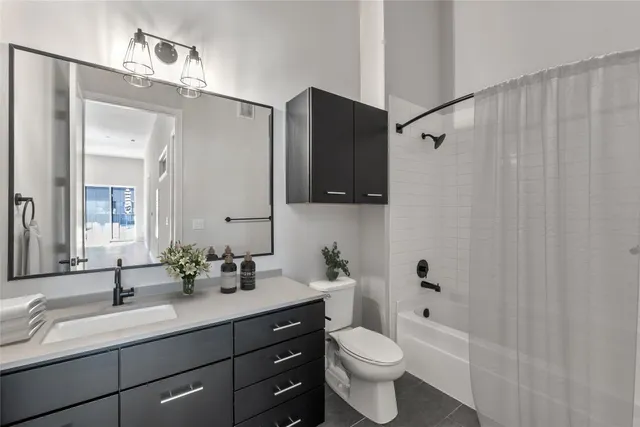 a bedroom with a bed and a painting on the wall