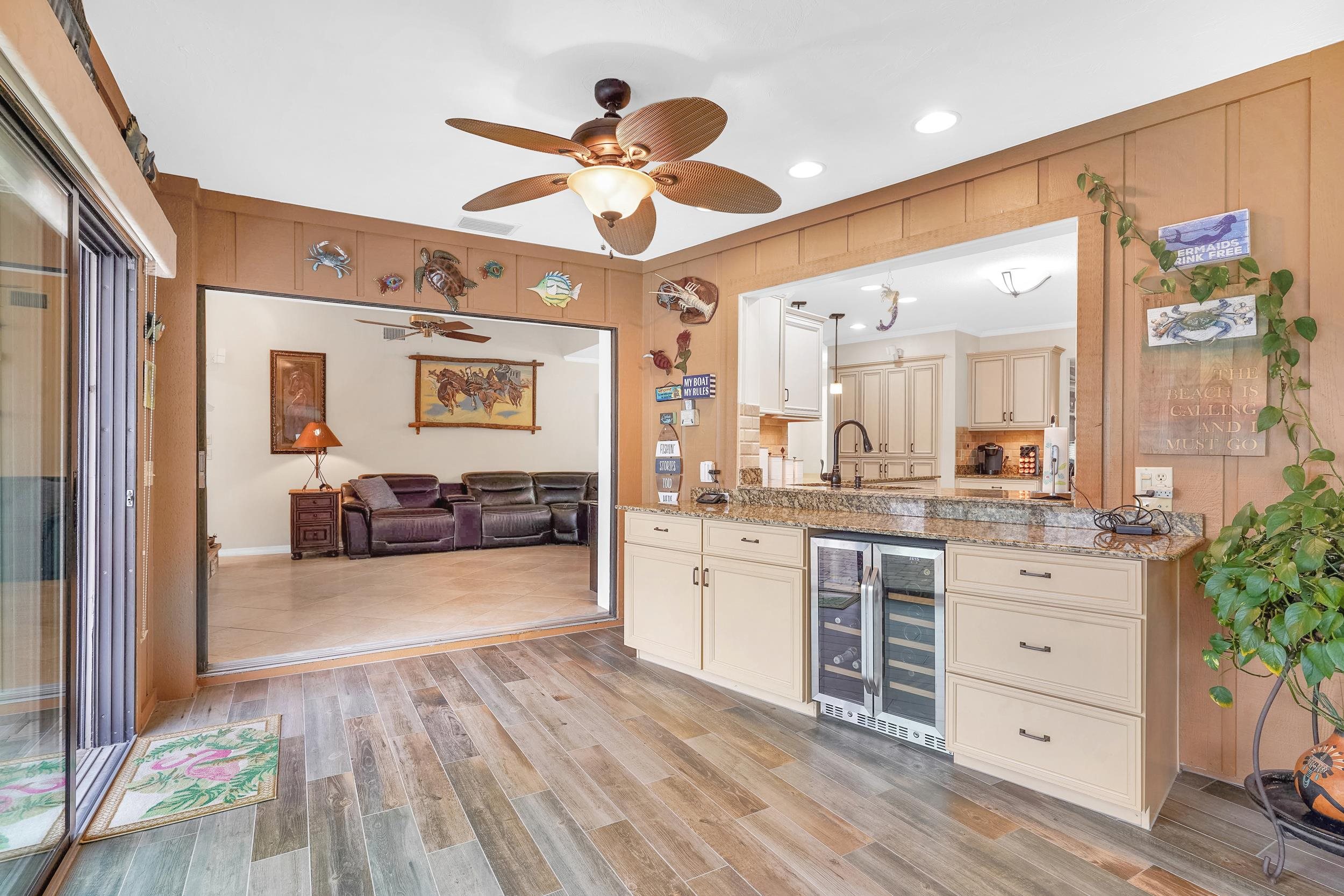 4 Calusa Court Palm Coast, FL 32137 - Photo 11 of 51 Bar area with a ceiling fan, recessed lighting, light stone countertops, wine cooler, and cream cabinets