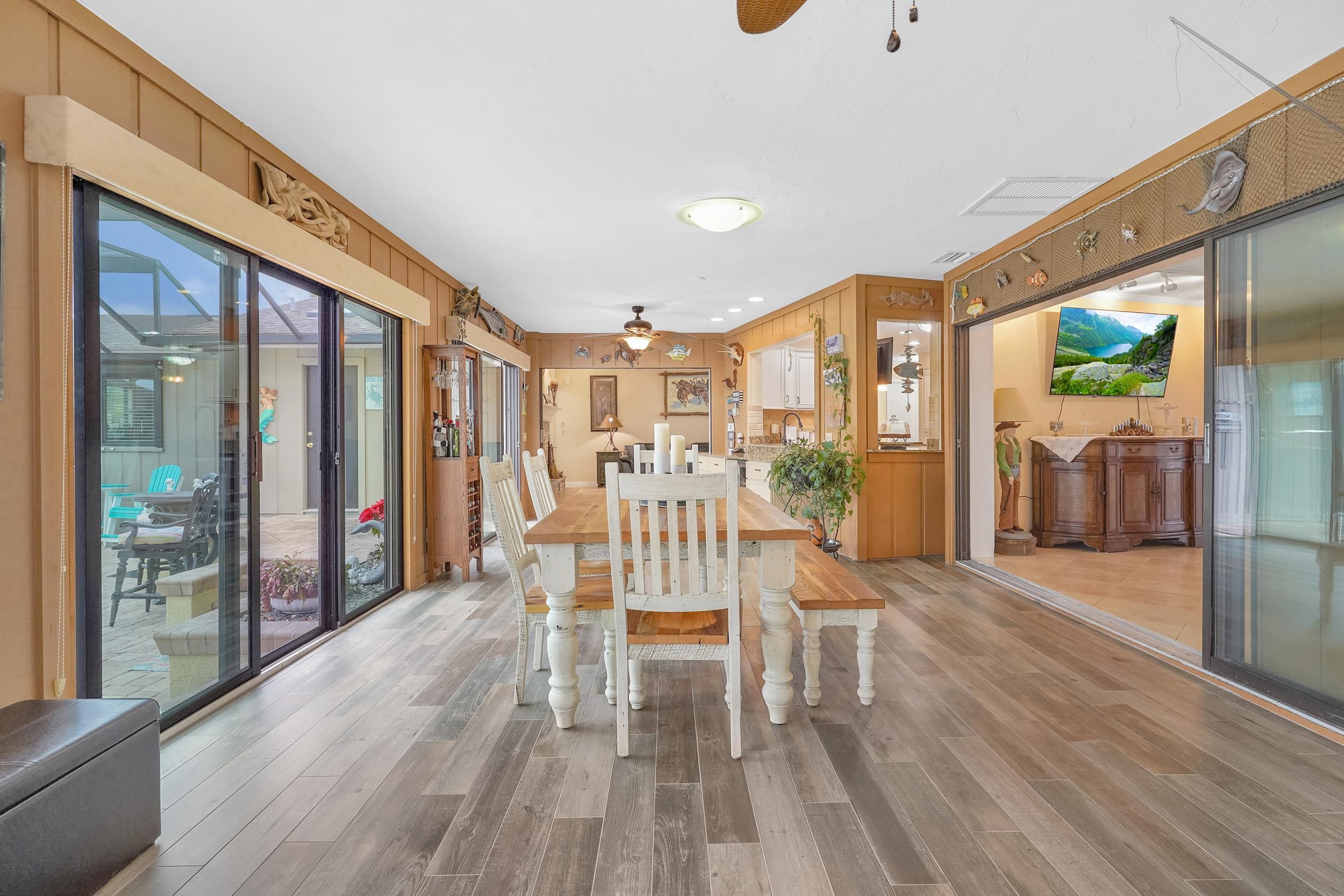 4 Calusa Court Palm Coast, FL 32137 - Photo 13 of 51 Dining room with a ceiling fan, wood walls, and light wood finished floors