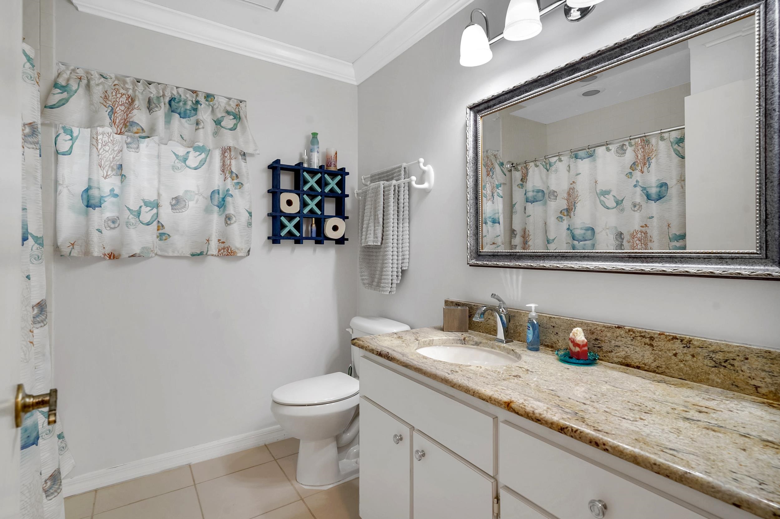 4 Calusa Court Palm Coast, FL 32137 - Photo 25 of 51 Bathroom with ornamental molding, a shower with shower curtain, vanity, and light tile patterned floors