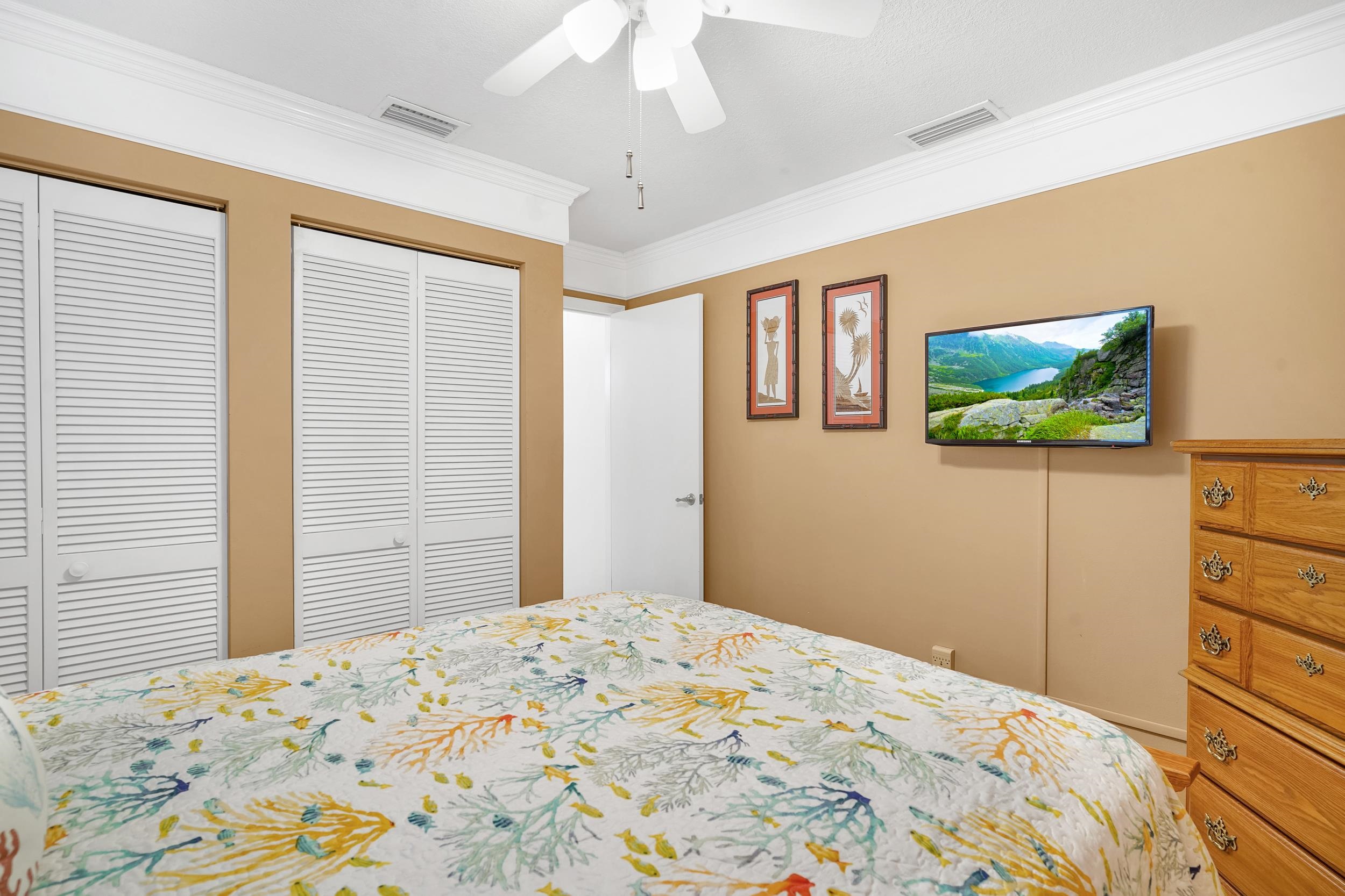 4 Calusa Court Palm Coast, FL 32137 - Photo 27 of 51 a bedroom with a bed and a flat screen tv