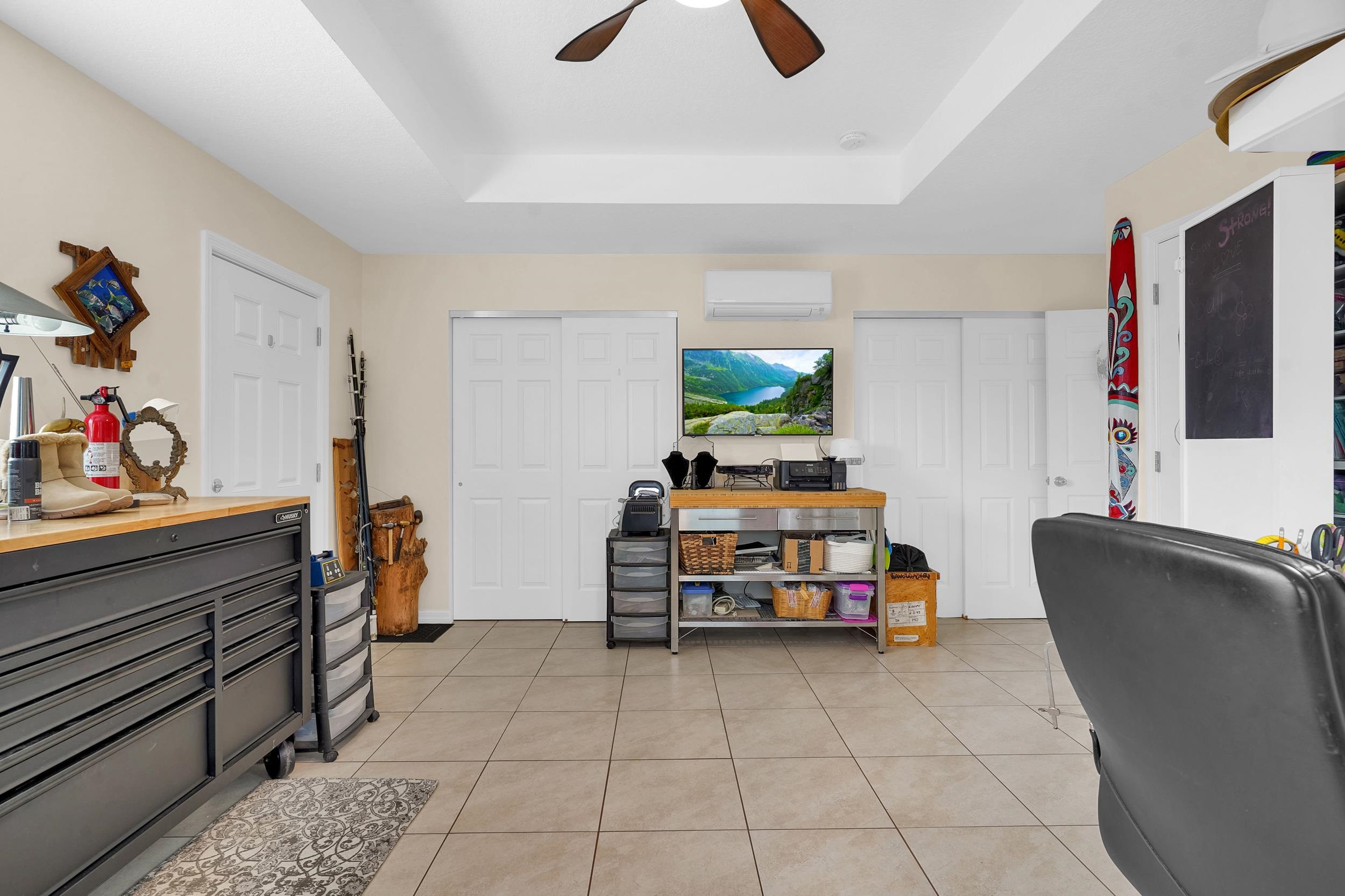 4 Calusa Court Palm Coast, FL 32137 - Photo 35 of 51 Office area with light tile patterned floors, ceiling fan, a tray ceiling, and a wall unit AC