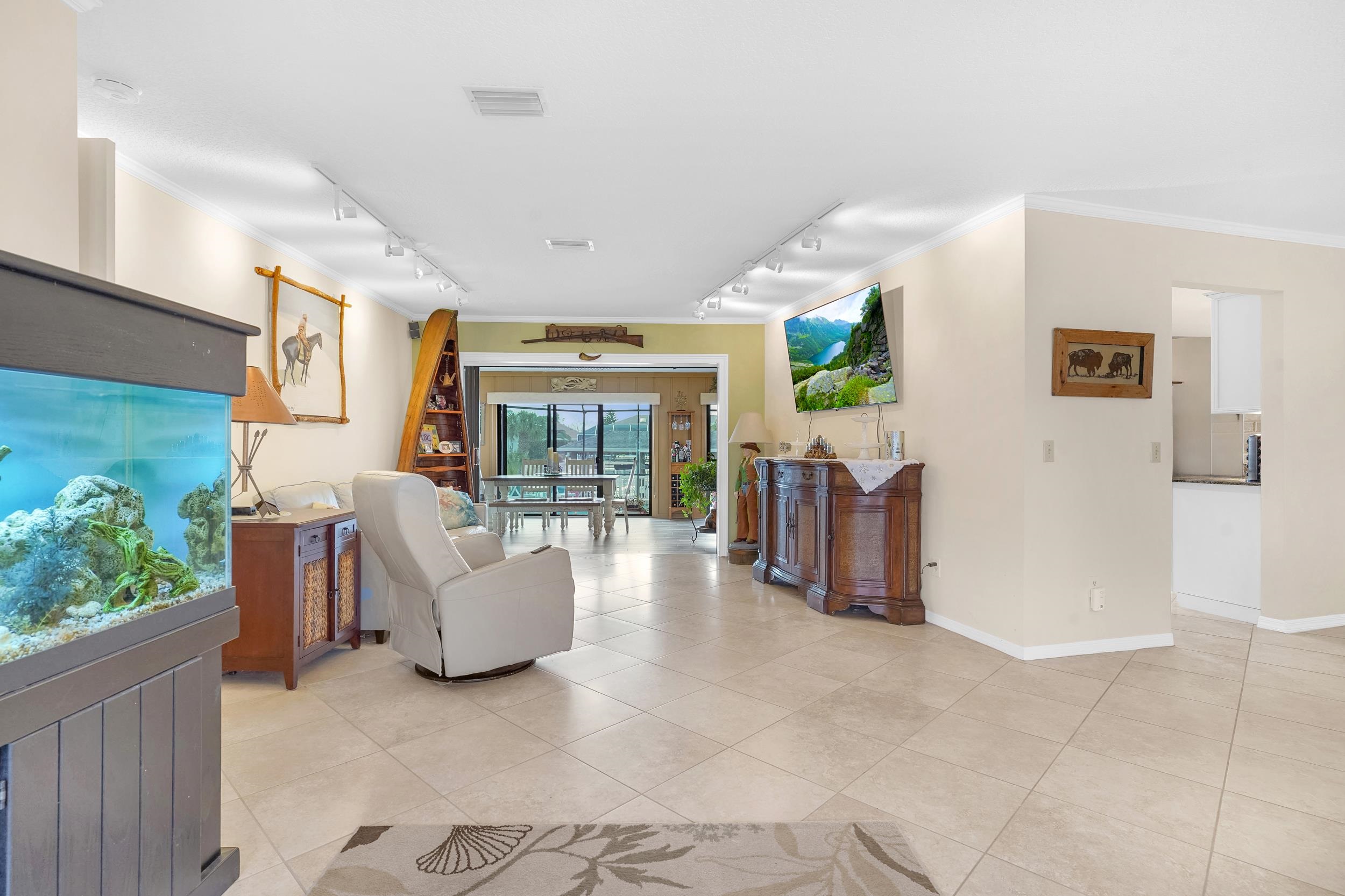 4 Calusa Court Palm Coast, FL 32137 - Photo 4 of 51 Hall featuring crown molding, light tile patterned floors, and track lighting