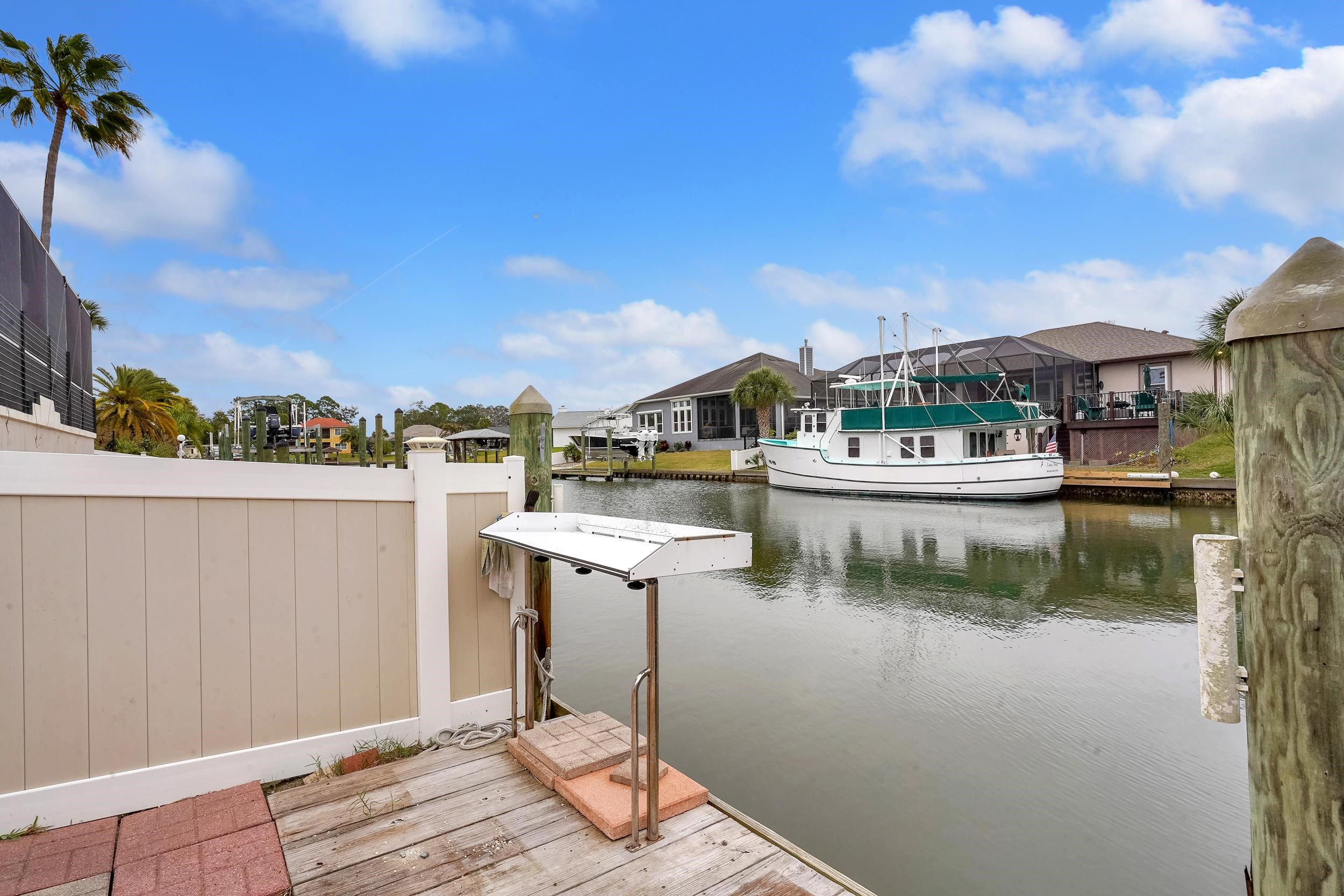 4 Calusa Court Palm Coast, FL 32137 - Photo 42 of 51 Dock featuring a water view and a residential view