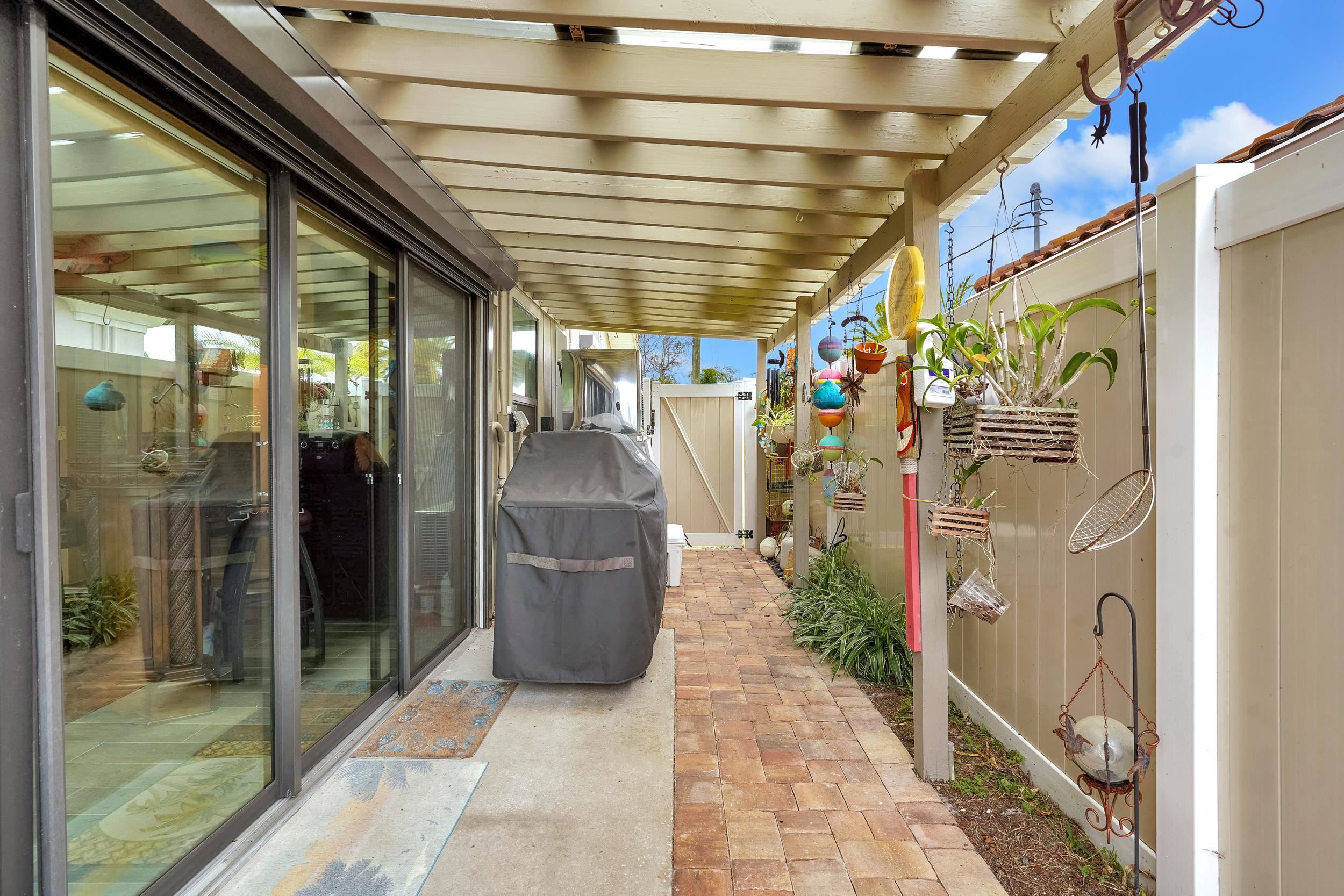 4 Calusa Court Palm Coast, FL 32137 - Photo 43 of 51 Fenced backyard with a grill, a patio area, and a pergola