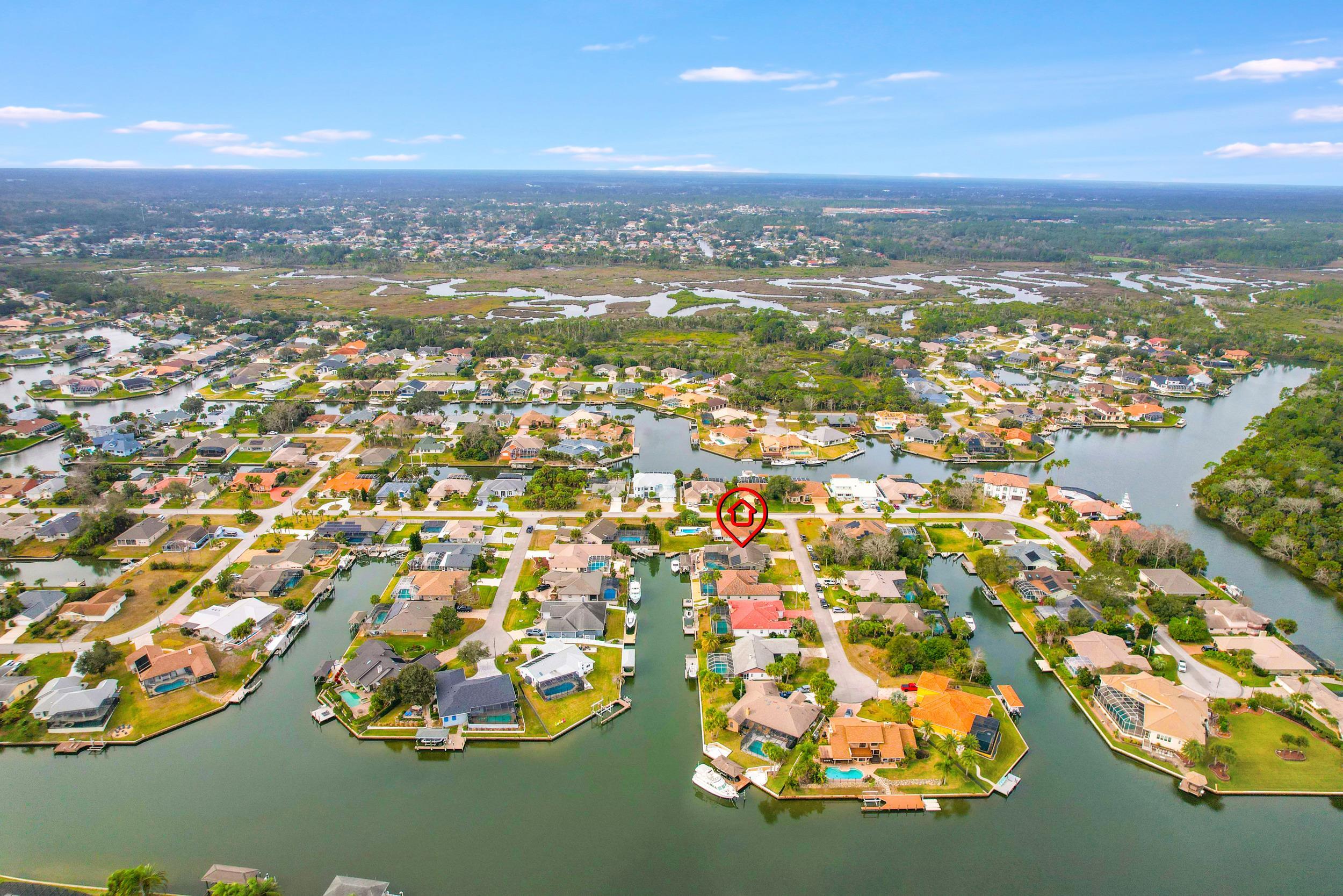4 Calusa Court Palm Coast, FL 32137 - Photo 48 of 51 Aerial overview of property's location with nearby suburban area and a nearby body of water