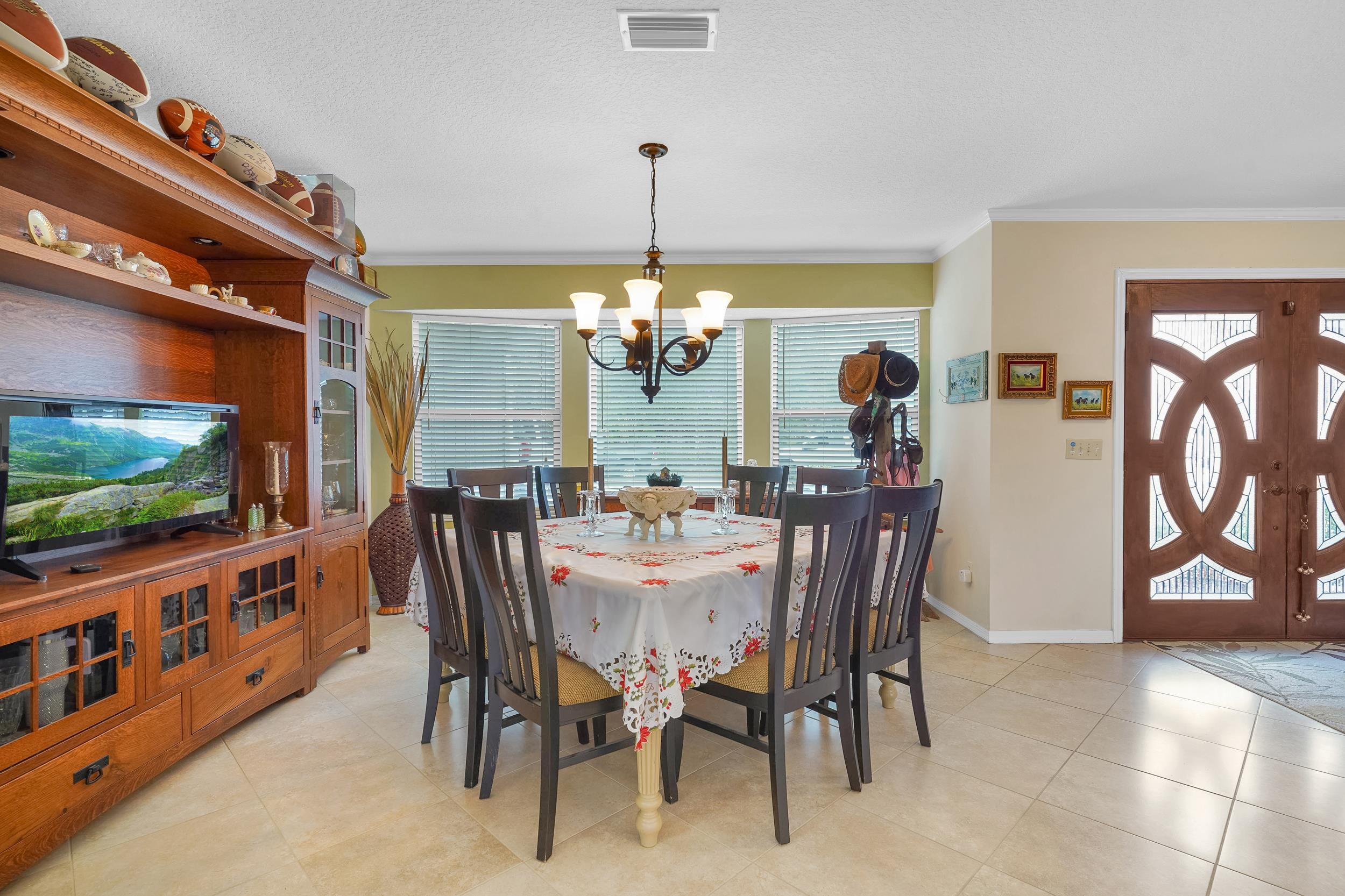 4 Calusa Court Palm Coast, FL 32137 - Photo 7 of 51 a view of a dining room with furniture window and wooden floor