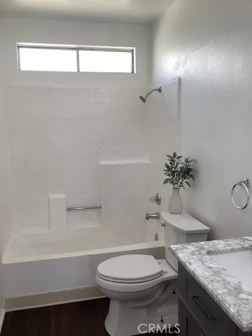 a bathroom with a granite countertop toilet a sink and bathtub