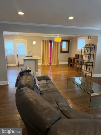 a living room with furniture pool table and a large window