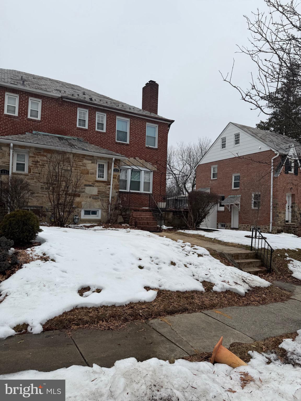 4814 Coleherne Road Baltimore, MD 21229 - Photo 7 of 8 a front view of a building with snow on the road