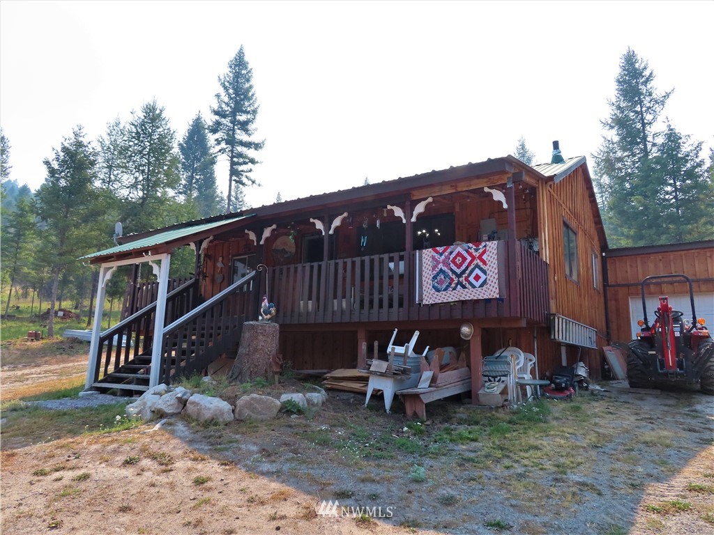 287 Mule Deer Road Republic, WA 99166 - Photo 1 of 25 a view of a house with a yard and deck