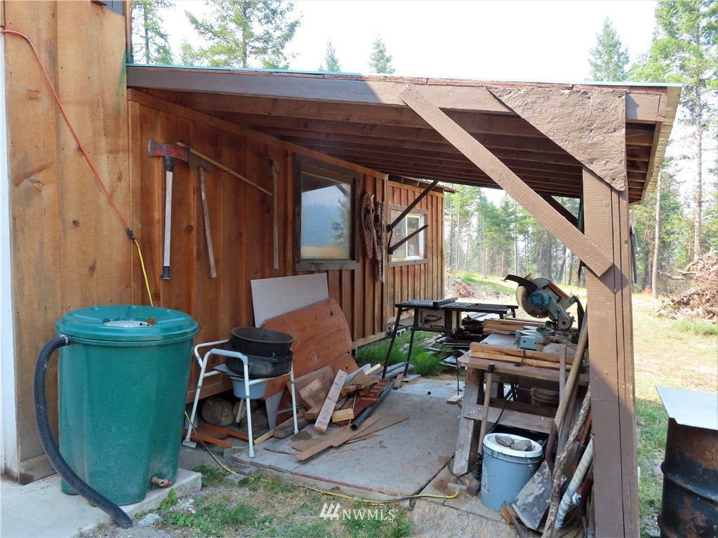 287 Mule Deer Road Republic, WA 99166 - Photo 14 of 25 a backyard of a house with chairs and a swing