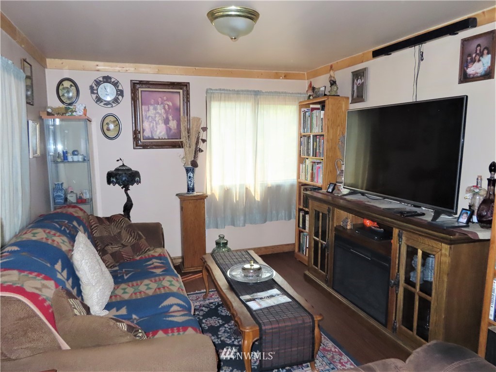 287 Mule Deer Road Republic, WA 99166 - Photo 3 of 25 a living room with furniture and a flat screen tv