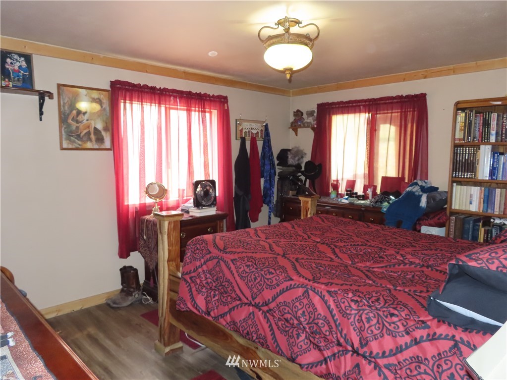 287 Mule Deer Road Republic, WA 99166 - Photo 9 of 25 a bed room with a bed and a window