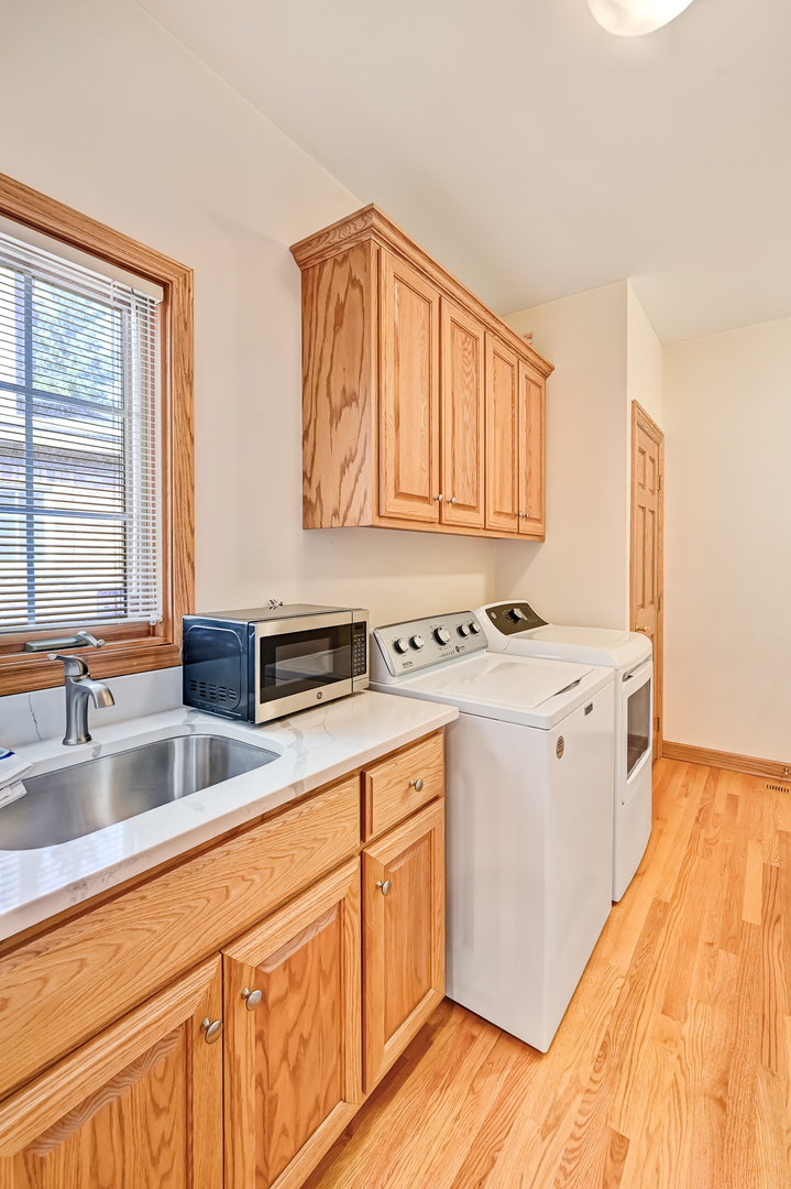 61 Berkshire Court Burr Ridge, IL 60527 - Photo 16 of 47 a kitchen with granite countertop white cabinets and white appliances