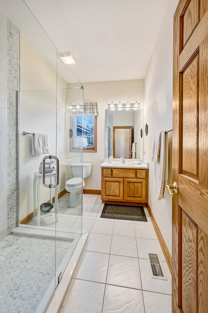 61 Berkshire Court Burr Ridge, IL 60527 - Photo 23 of 47 a kitchen with stainless steel appliances kitchen island granite countertop a refrigerator and a stove