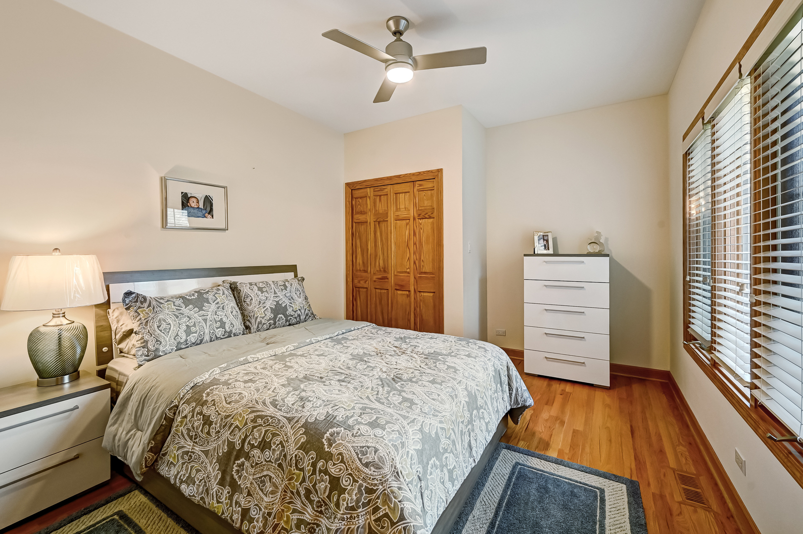 61 Berkshire Court Burr Ridge, IL 60527 - Photo 25 of 47 a bedroom with a bed and a flat tv screen on dresser